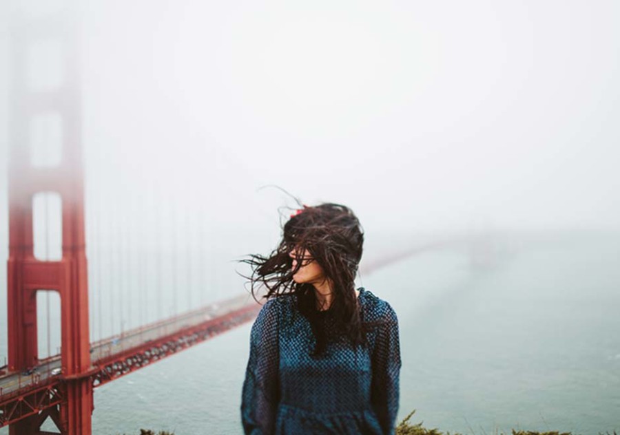 AcuGroup- an adult with long hair outside by Golden Gate Bridge