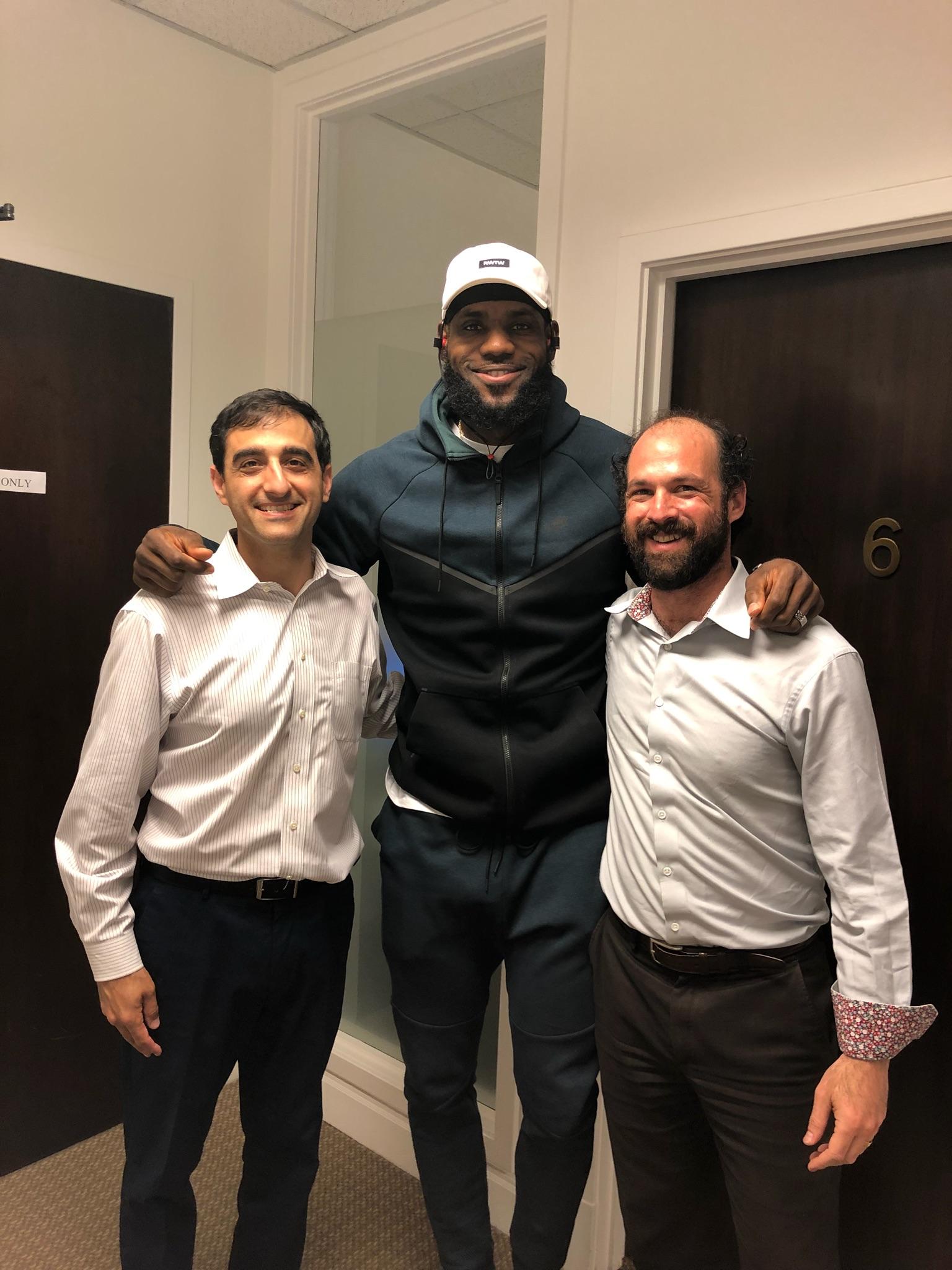 LeBron with his arms around the AcuGroup directors' shoulders